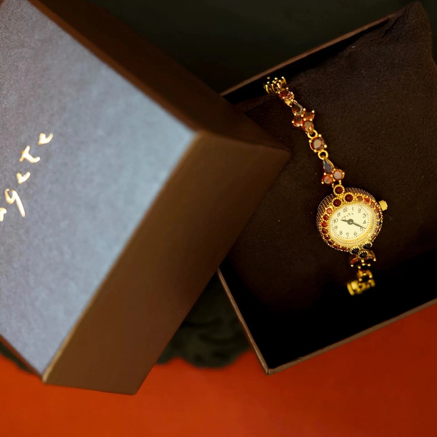 Red Crystal-Embellished Gold Women’s Watch